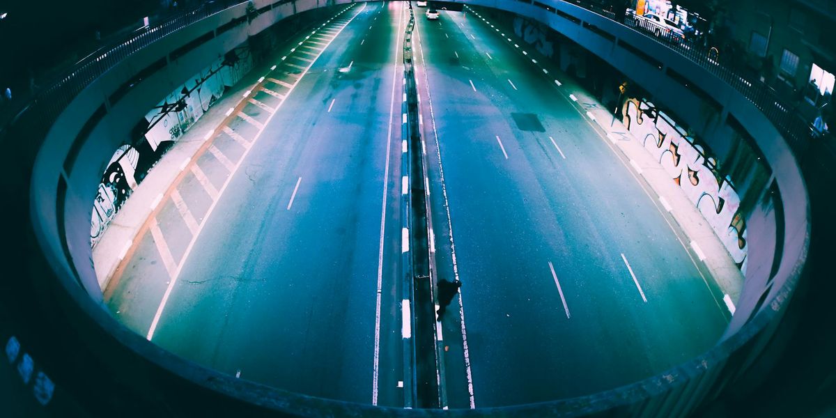 Empty modern training hall with neon magenta lighting accents.
